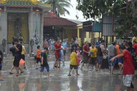 Devotees having fun splashing water at each other