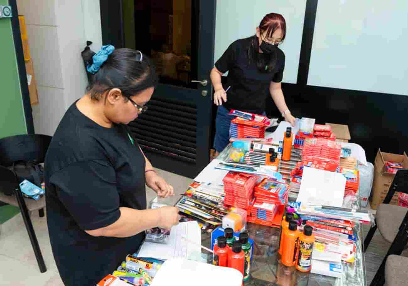 Volunteers pack essential supplies for remote preschools, empowering Orang Asli children through FBS & SUKA Society's partnership.